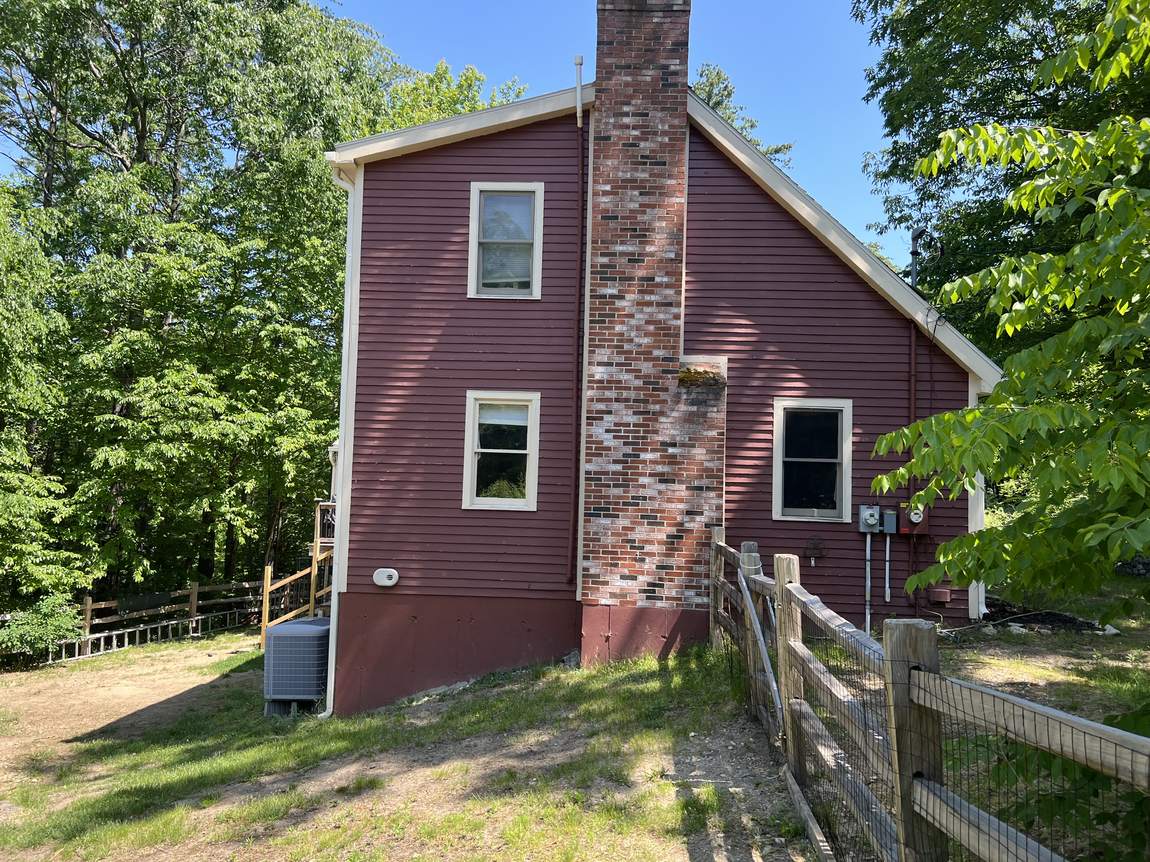 Gable end before work began, with the original exterior chimney