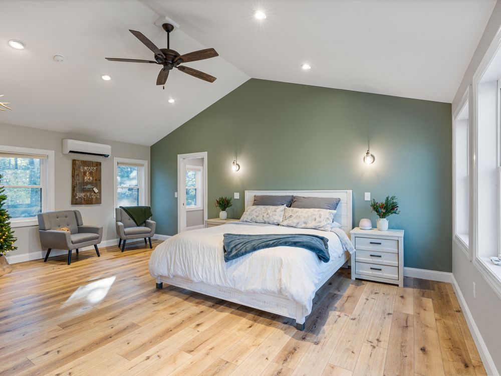 Primary suite with vaulted ceiling and sage accent wall