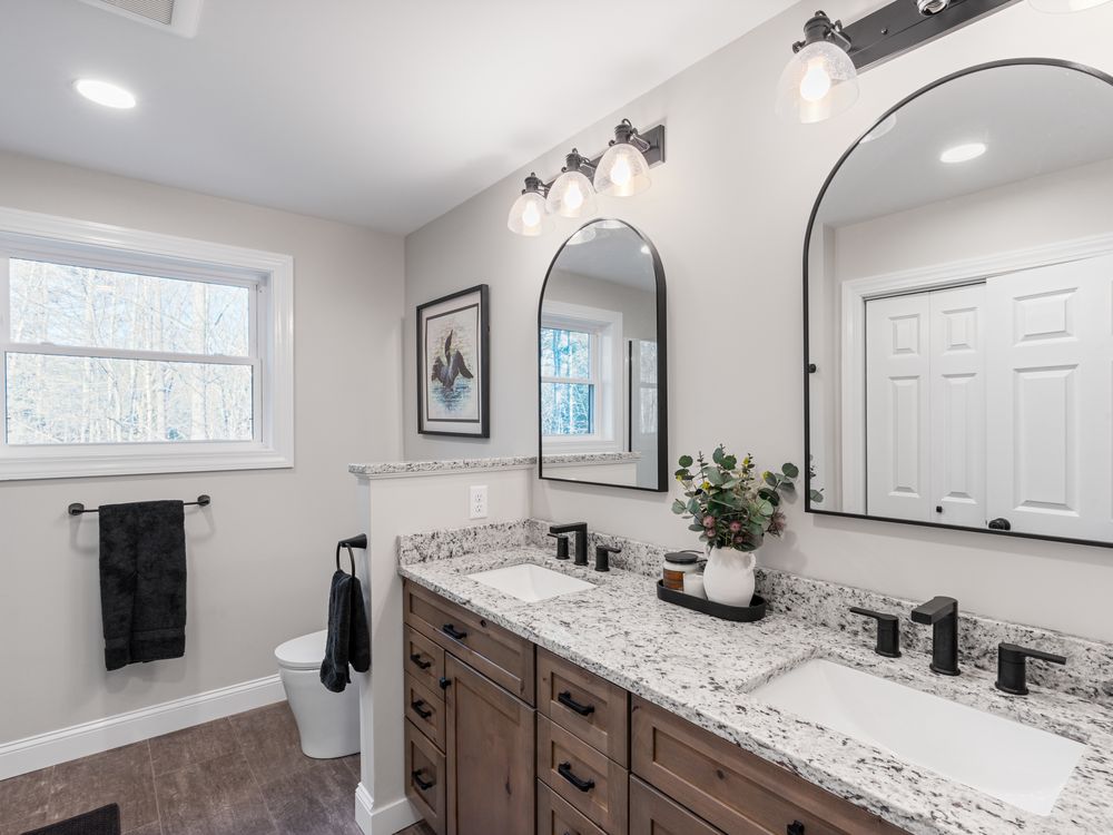Primary bath with double vanity and arched mirrors