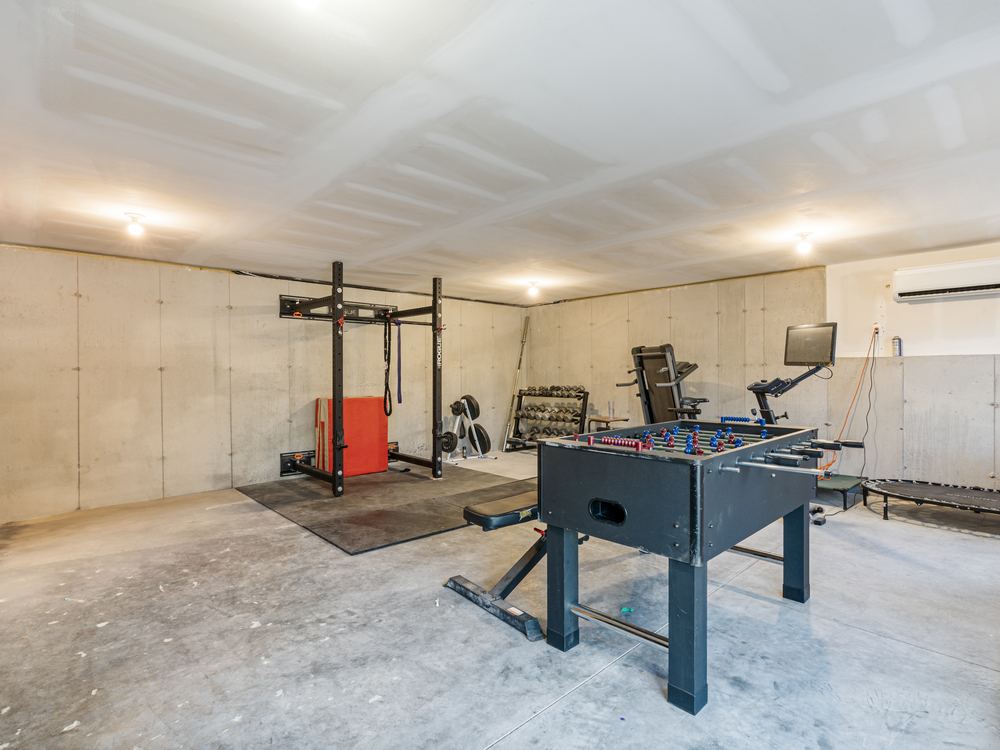 Lower level created by the addition, left unfinished by design and now in use as a home gym