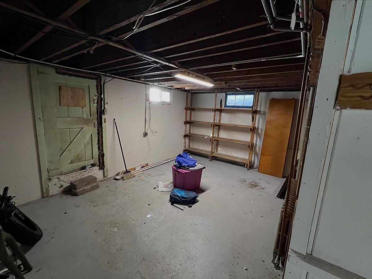Storage area stripped back, joists and utilities exposed