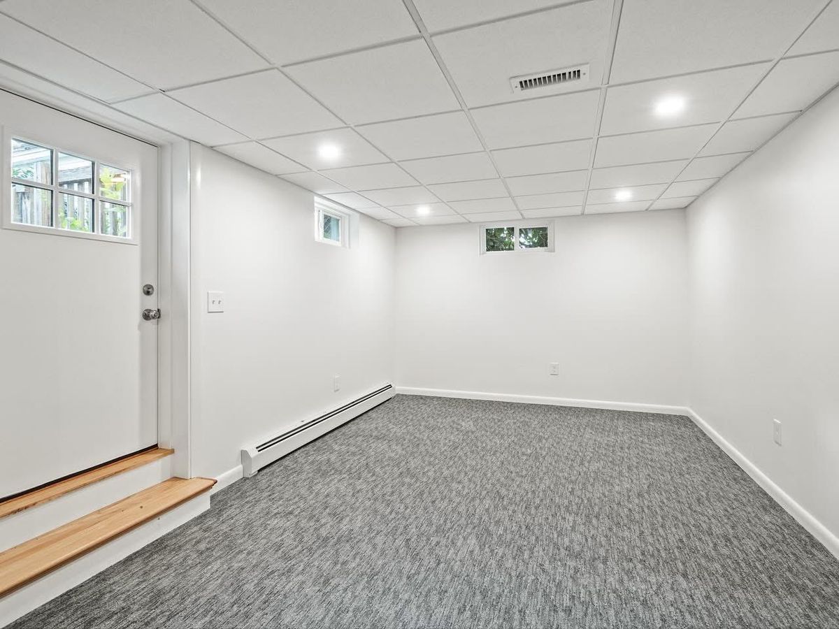 Finished room with drop ceiling, recessed lighting and new carpet