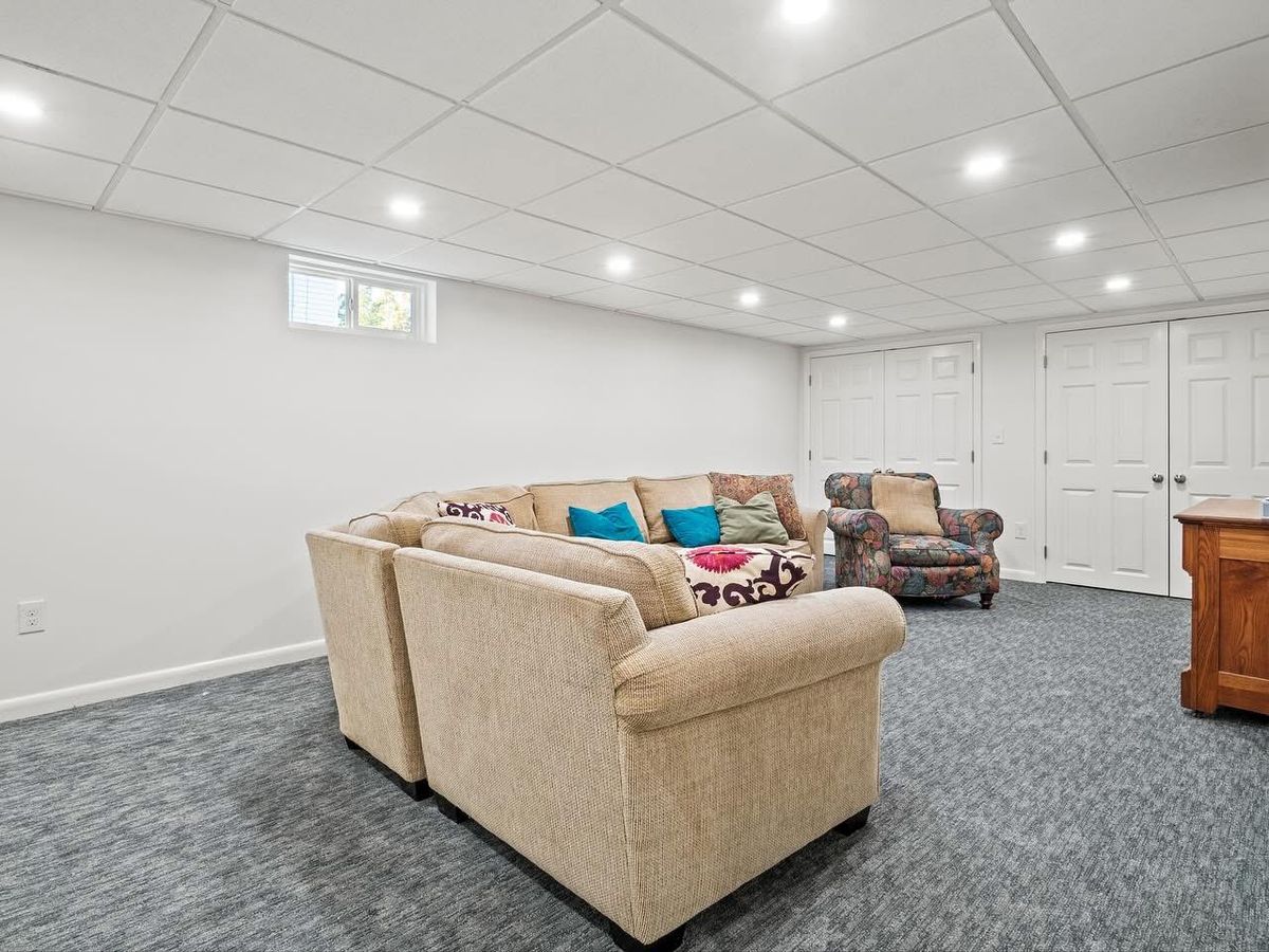 Finished family room with recessed lighting and new carpet