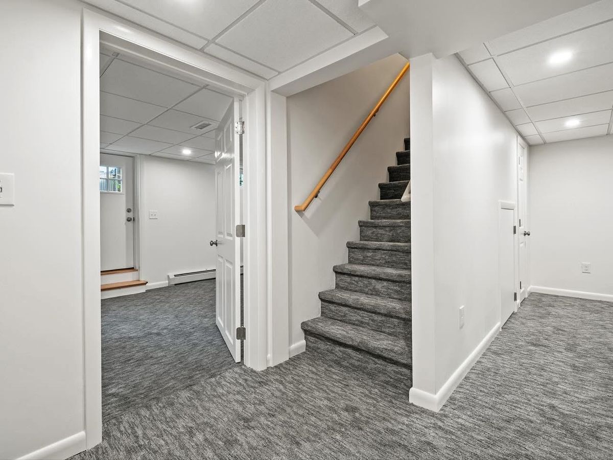 Finished landing with carpeted stairs and new handrail