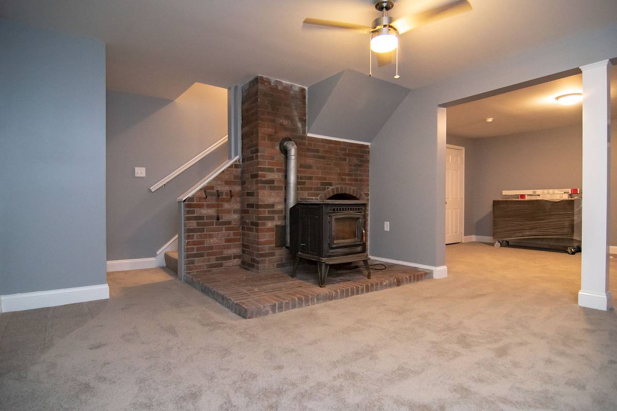 The same chimney rebuilt and finished, with new carpet, stairs and woodstove hearth