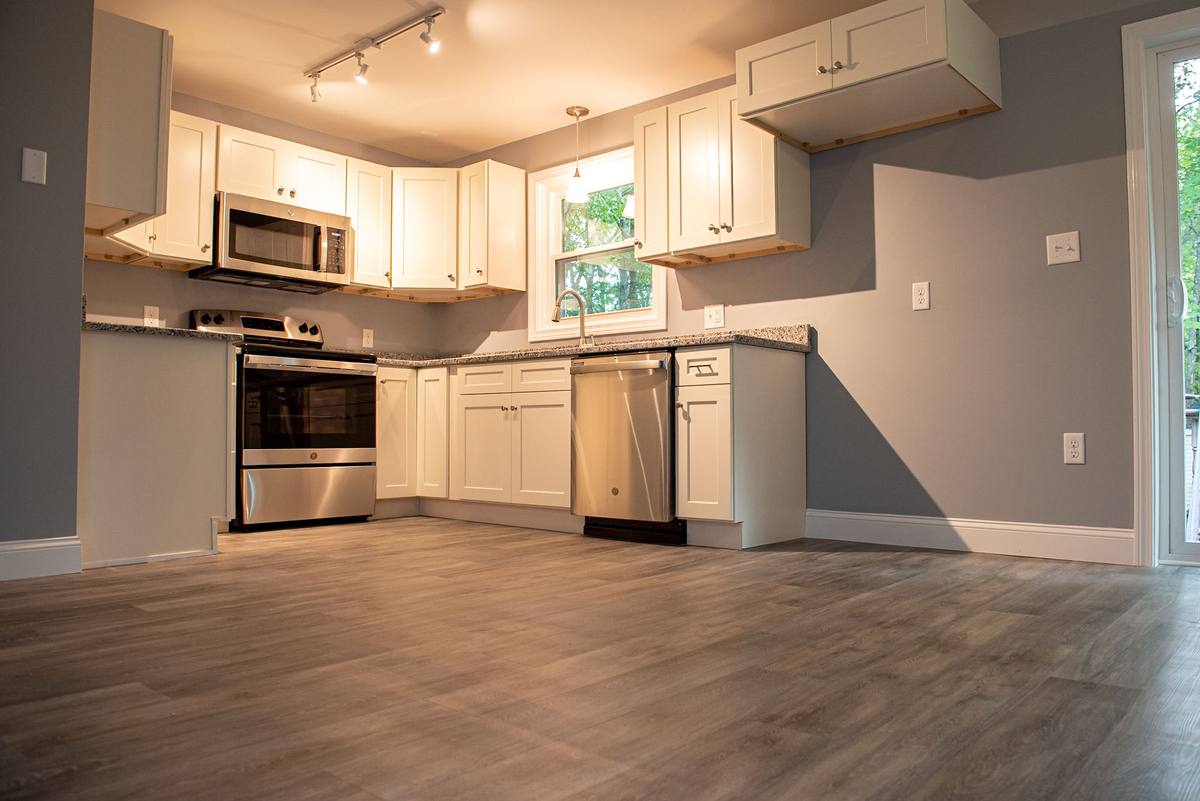 New kitchen with shaker cabinetry, granite counters and stainless appliances