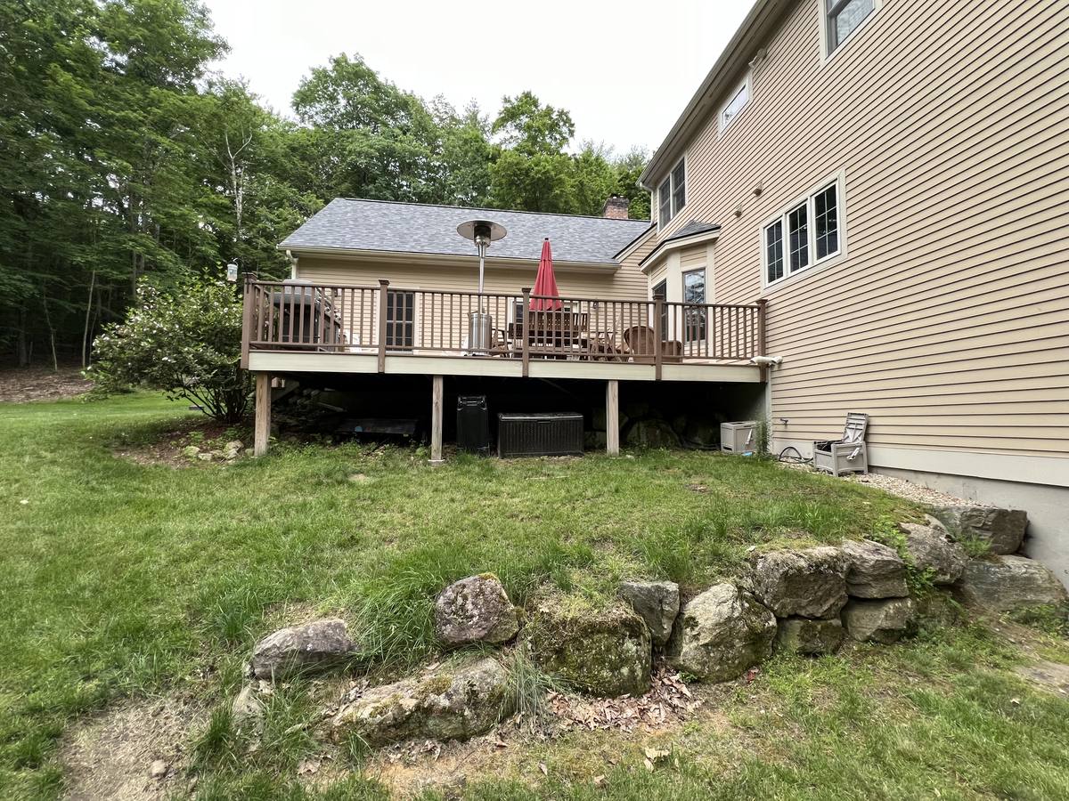 The original rear deck, smaller and framed with wood railings