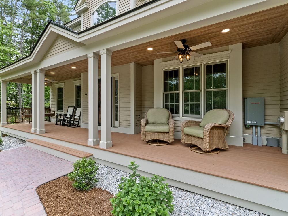 The porch running the full length of the house, with seating between the columns