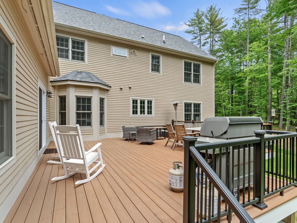 Composite deck with grilling area and black metal railing