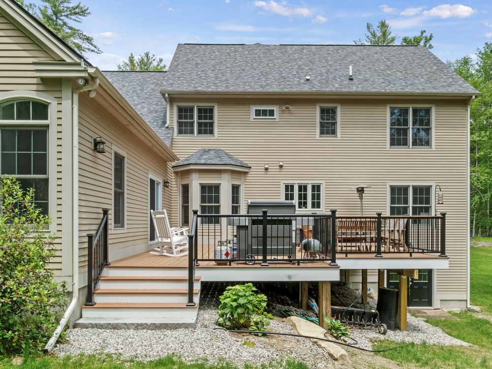 Rear elevation showing the new deck, railings and stairs down to the yard