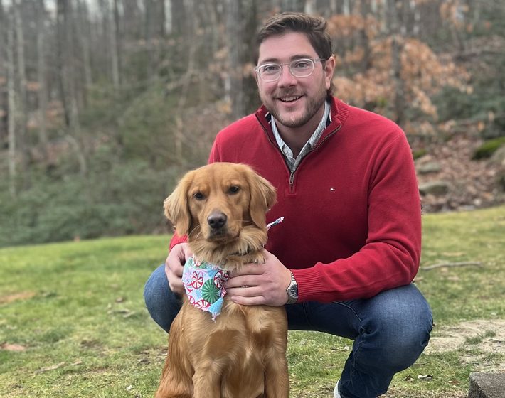 Parker LeClerc with Ellie, the company golden retriever