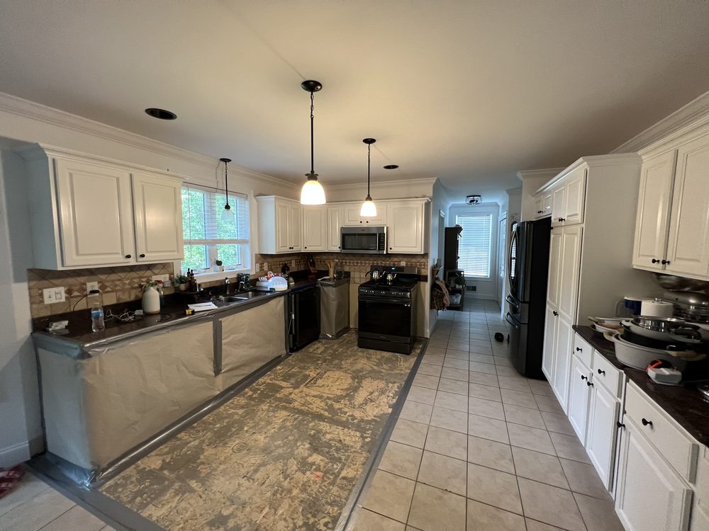 Kitchen after water damage — flooring removed for drying